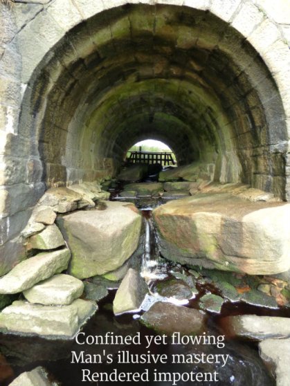 image of stream in culvert - confined-yet-flowing-mans-illusive-mastery-rendered-impotent