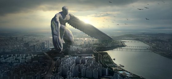 stone angel kneeling above a city